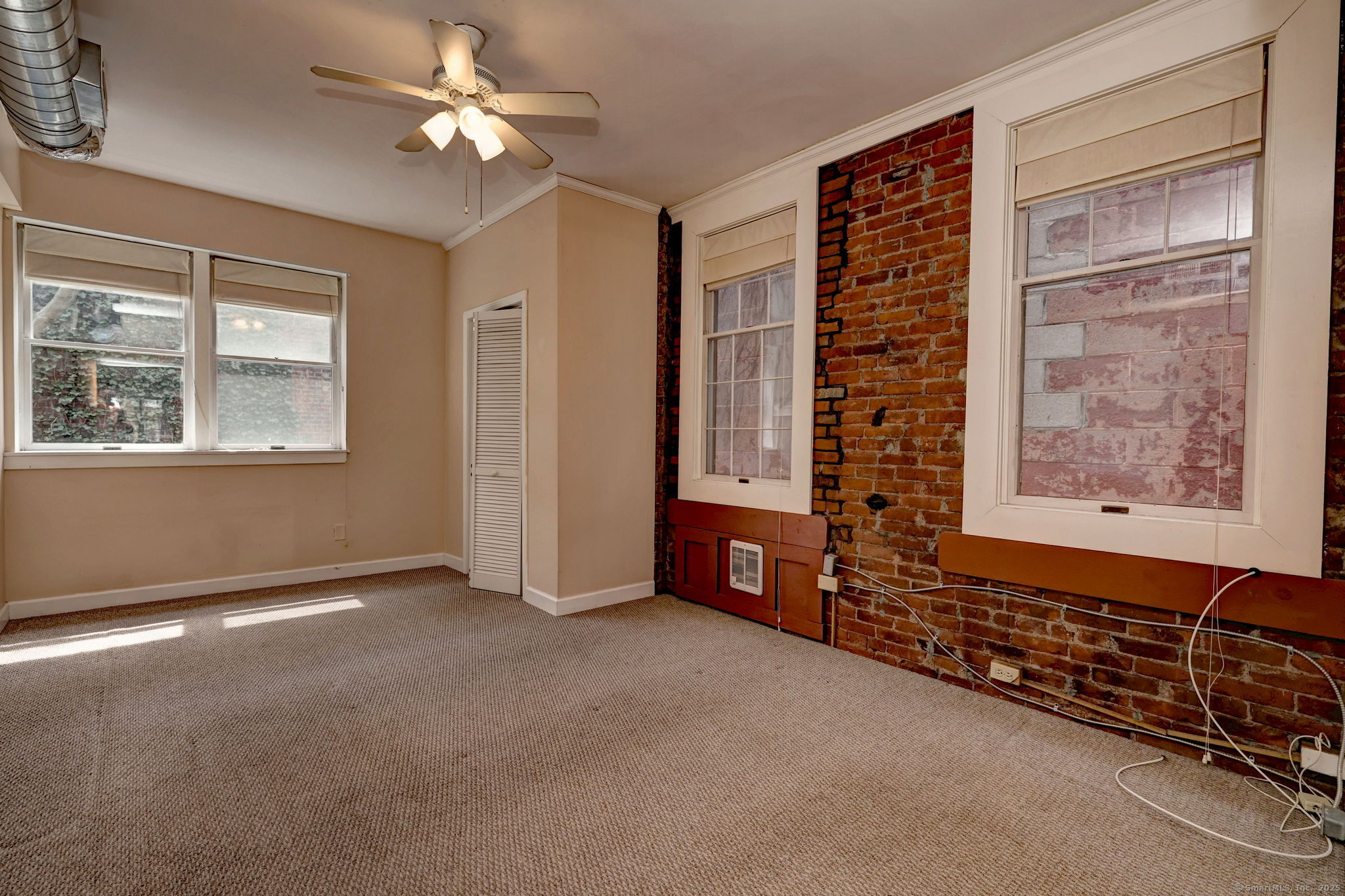 844 Grand Avenue, Unit 2 New Haven, CT 06511 - Photo 28 of 36 an empty room with windows closet and chandelier fan