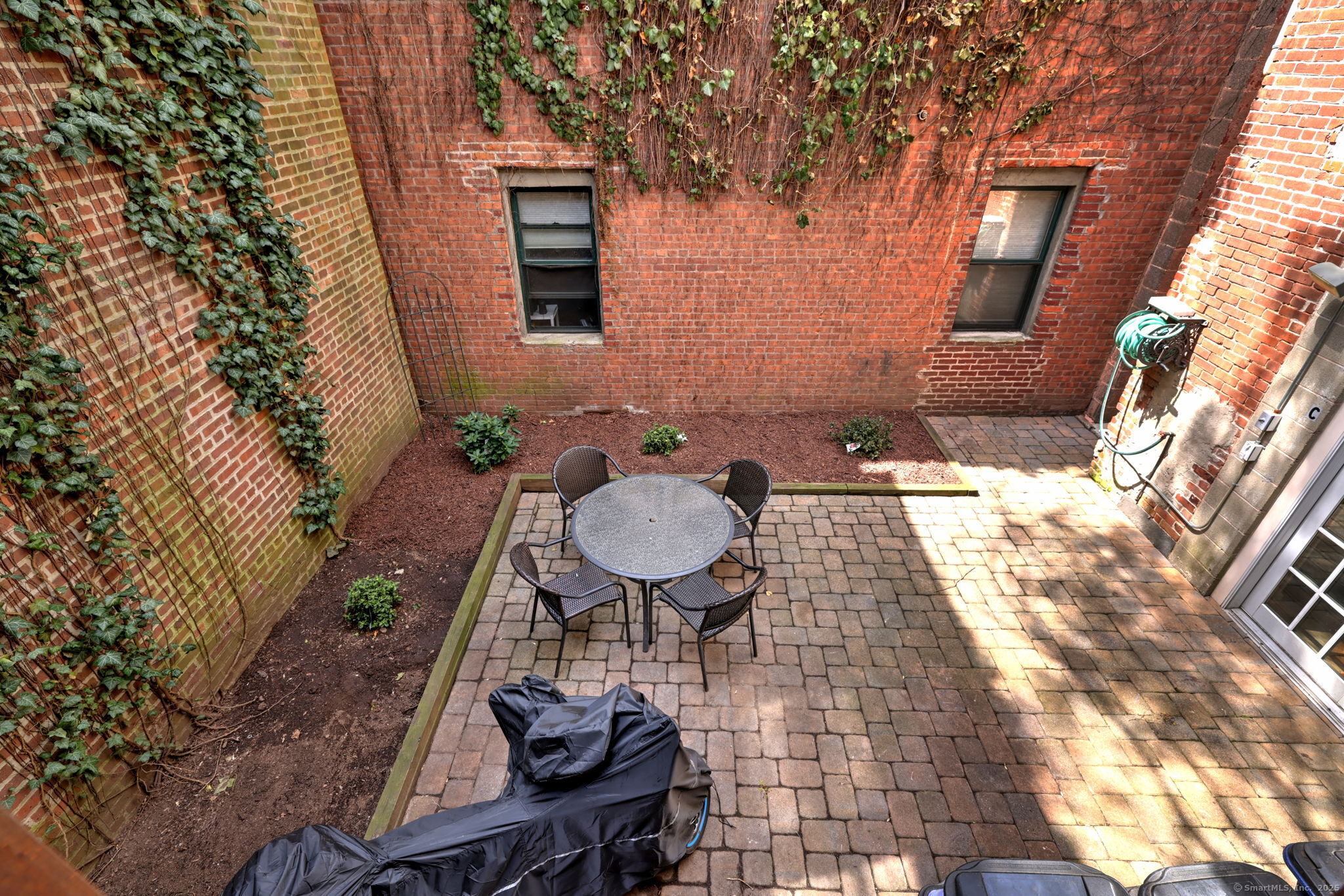 844 Grand Avenue, Unit 2 New Haven, CT 06511 - Photo 34 of 36 a backyard of a house with table and chairs