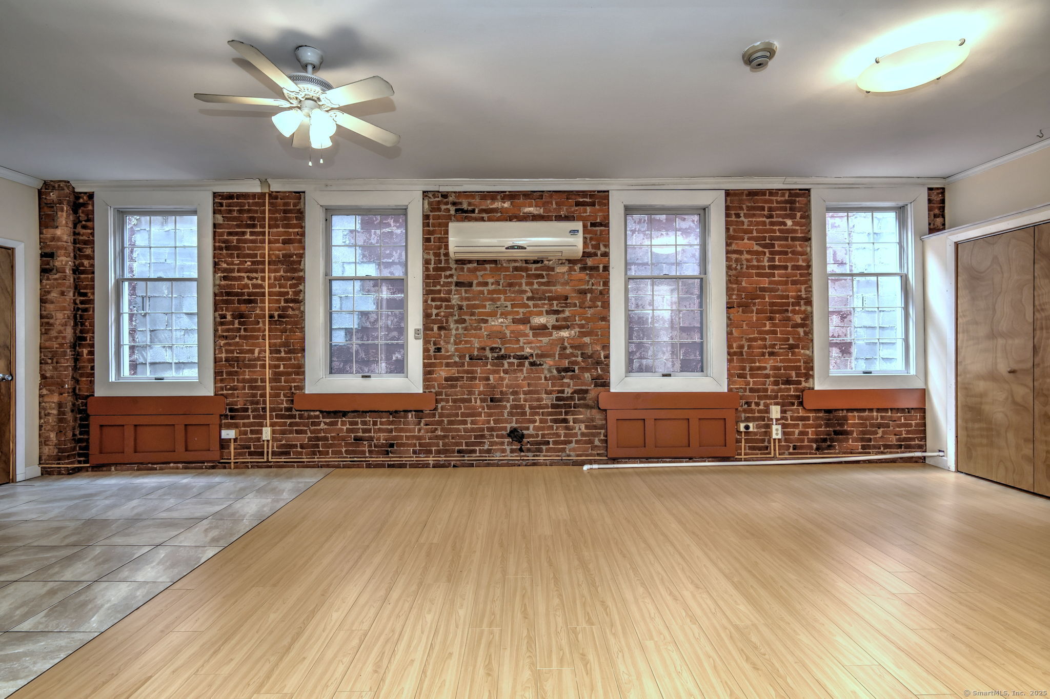 844 Grand Avenue, Unit 2 New Haven, CT 06511 - Photo 5 of 36 a view of an empty room with a window and wooden floor