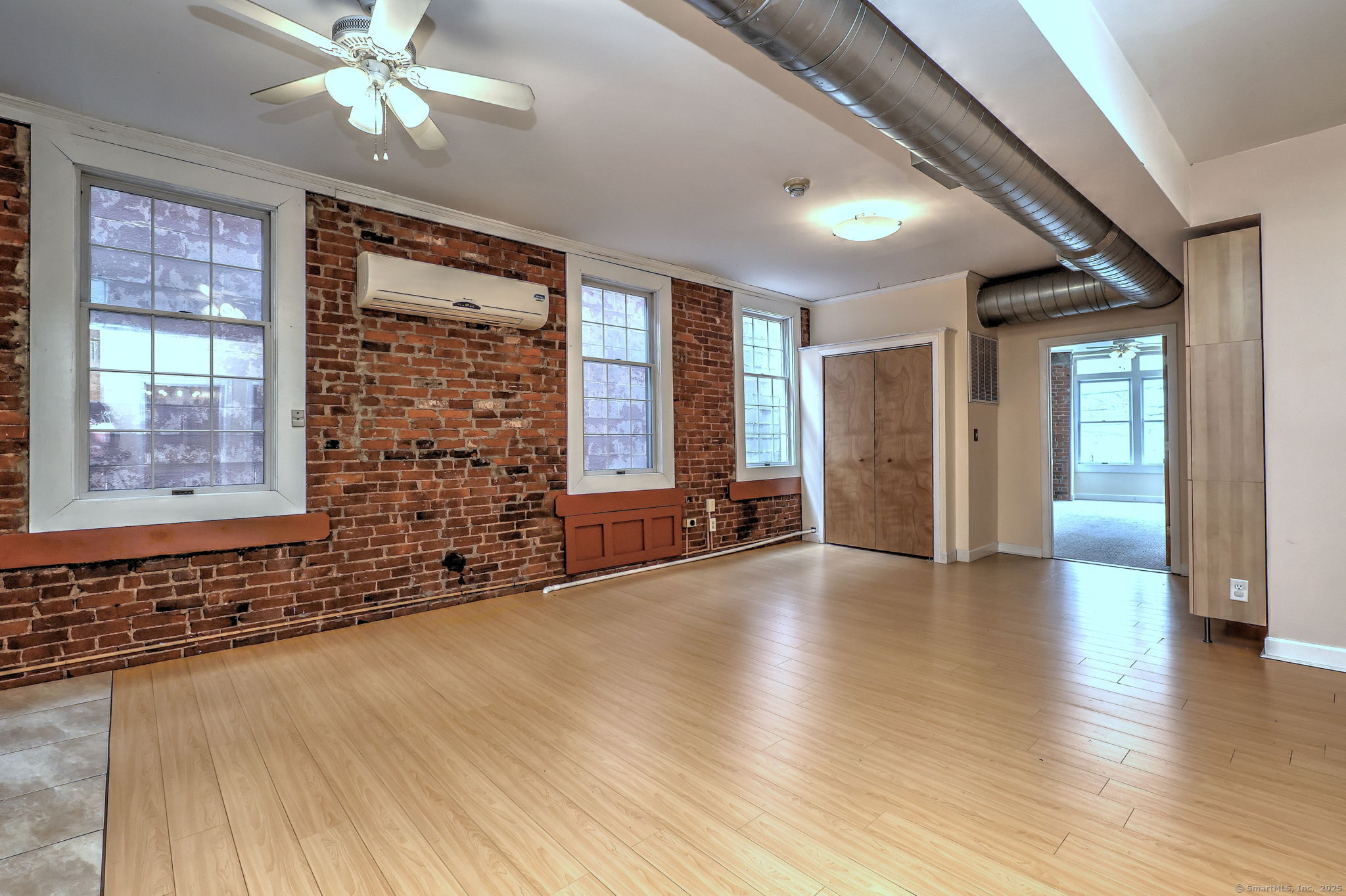 844 Grand Avenue, Unit 2 New Haven, CT 06511 - Photo 6 of 36 a view of an empty room with wooden floor and a window