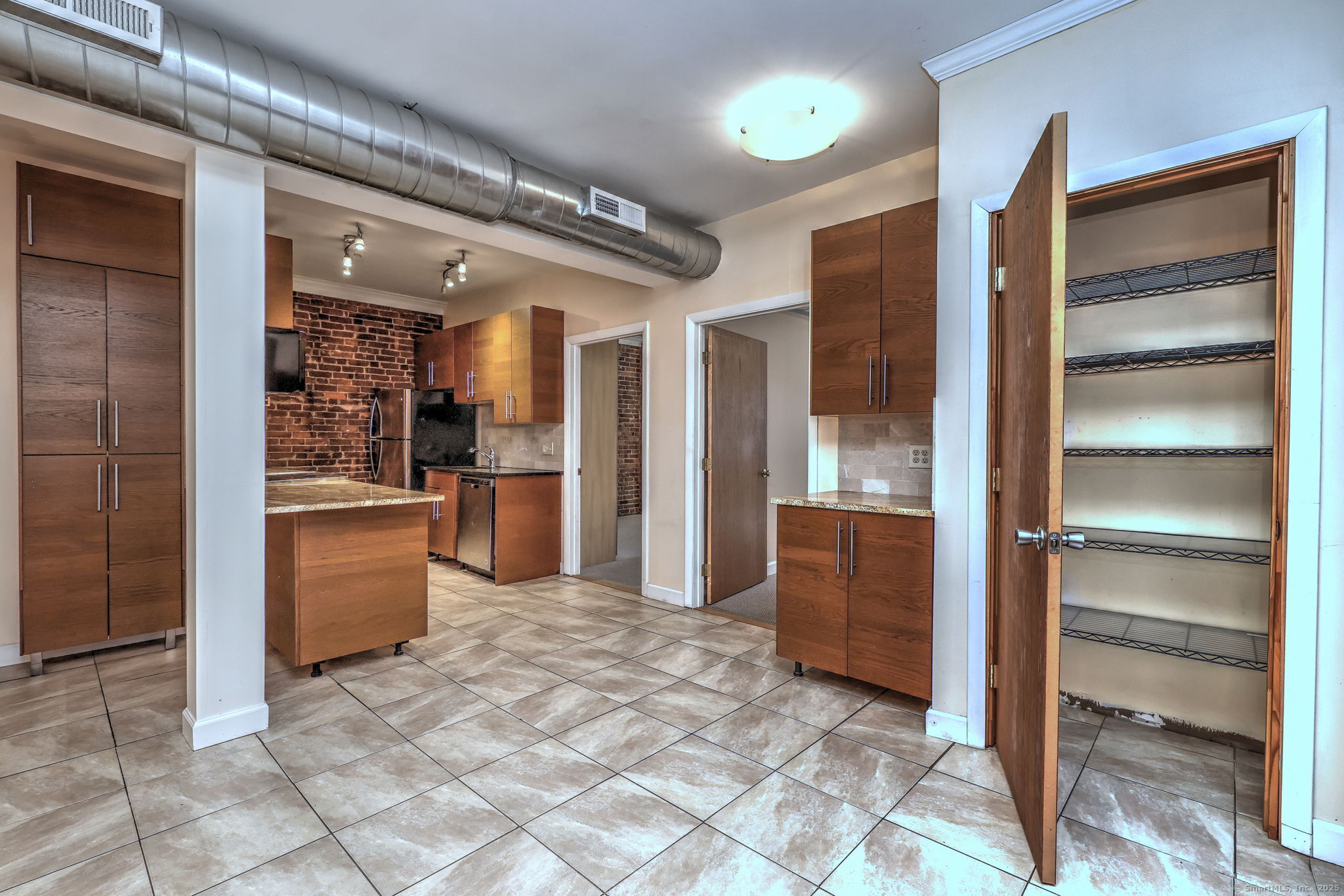 844 Grand Avenue, Unit 2 New Haven, CT 06511 - Photo 10 of 36 a kitchen with granite countertop a refrigerator and cabinets