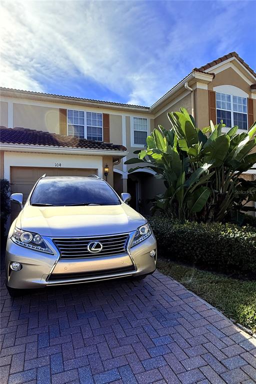 6360 Ranelagh Drive, Unit 104 Orlando, FL 32835 - Photo 1 of 18 a car parked in front of a house