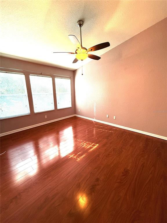 6360 Ranelagh Drive, Unit 104 Orlando, FL 32835 - Photo 13 of 18 a view of an empty room with window and wooden floor