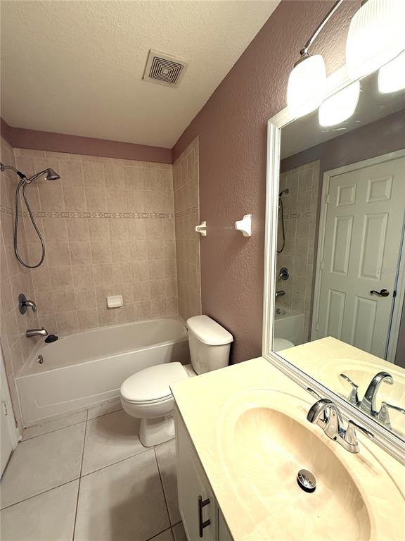 6360 Ranelagh Drive, Unit 104 Orlando, FL 32835 - Photo 17 of 18 a bathroom with a sink a toilet and shower