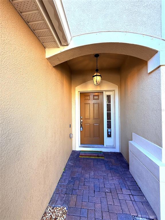 6360 Ranelagh Drive, Unit 104 Orlando, FL 32835 - Photo 2 of 18 a view of a hallway with wooden floor and a large window