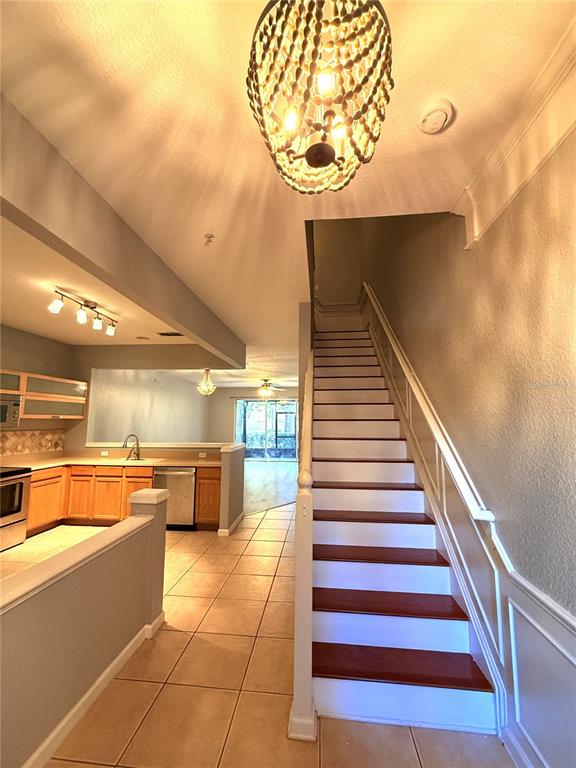6360 Ranelagh Drive, Unit 104 Orlando, FL 32835 - Photo 3 of 18 a view of a kitchen with a sink and cabinets