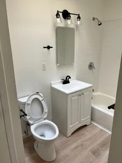a bathroom with a sink toilet and shower