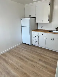 a view of kitchen with white cabinets