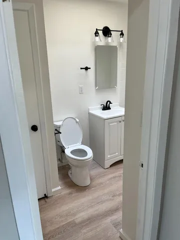 a white toilet sitting next to a white sink