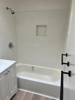 a bathroom with a bathtub and a shower