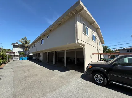 a view of a house and a car parked in front of it