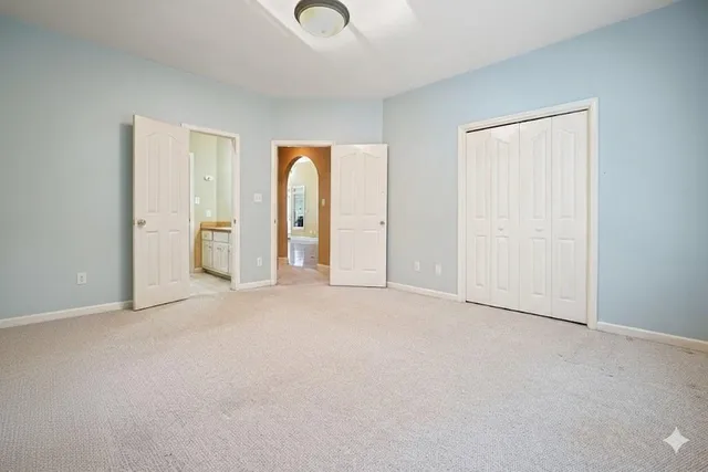 a view of a house with backyard and trees