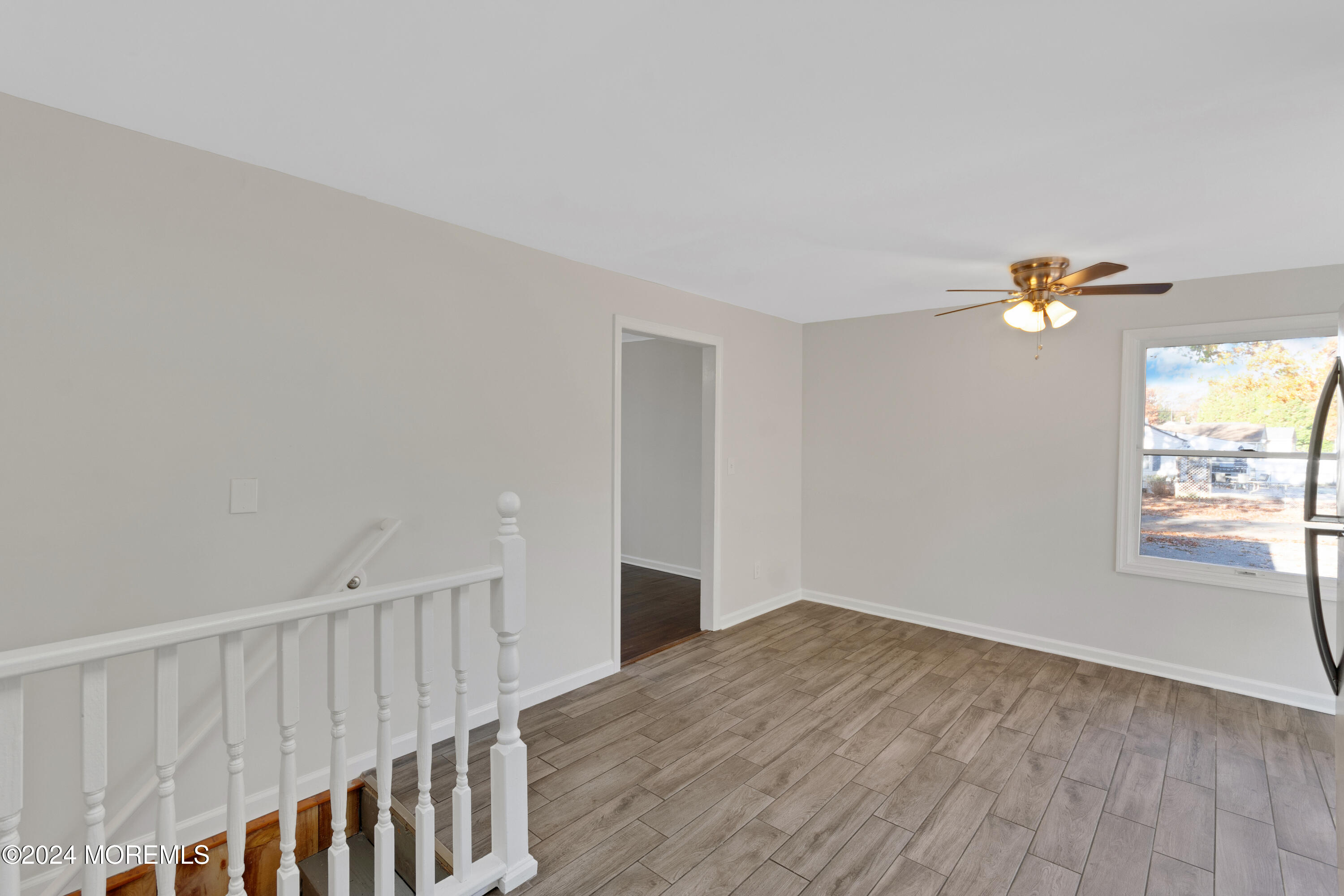1718 Forge Pond Road Brick, NJ 08724 - Photo 18 of 29 a view of an empty room with wooden floor and a window