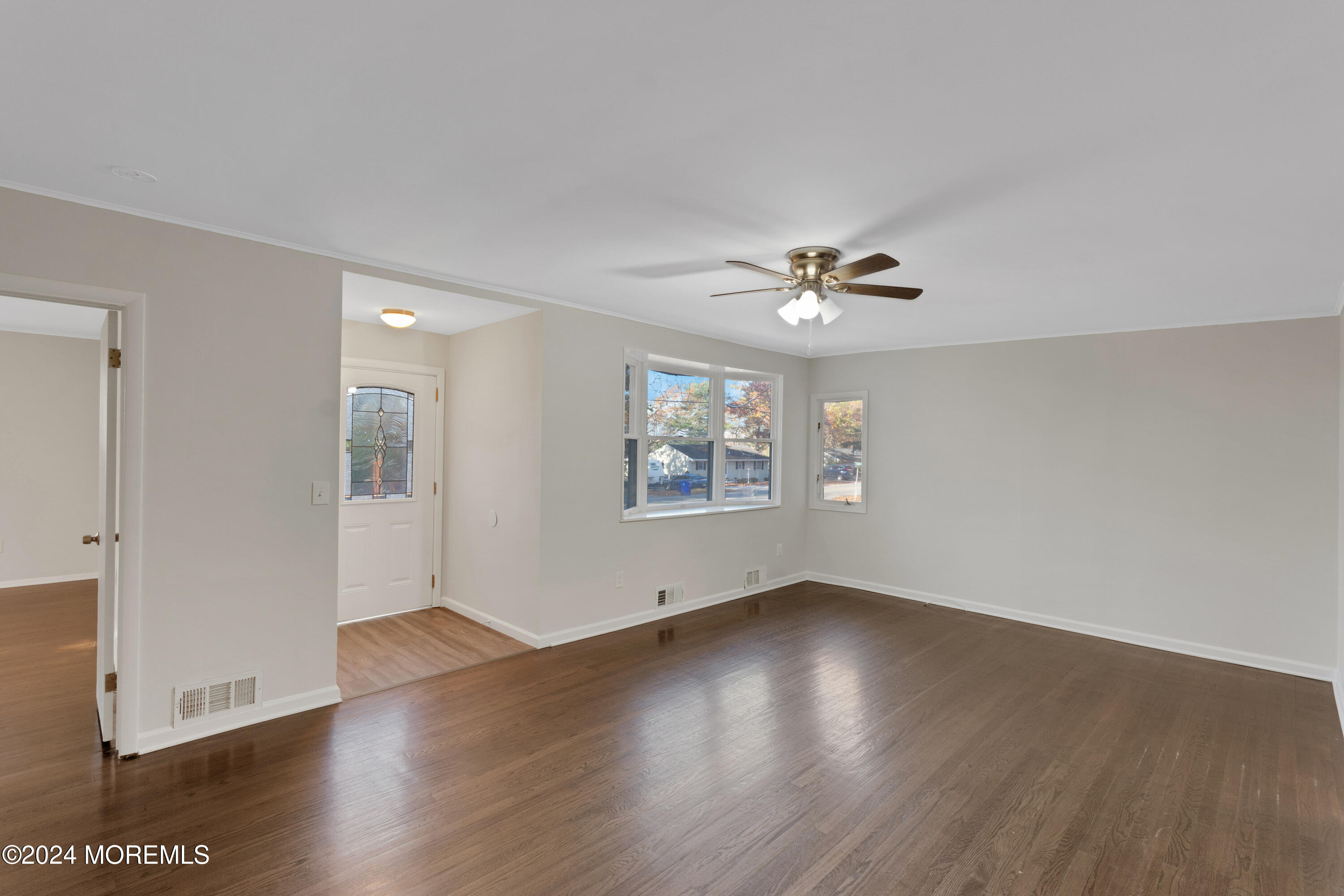 1718 Forge Pond Road Brick, NJ 08724 - Photo 6 of 29 an empty room with wooden floor and windows