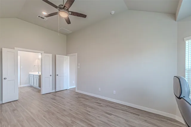 a bathroom with a double vanity sink a toilet and shower