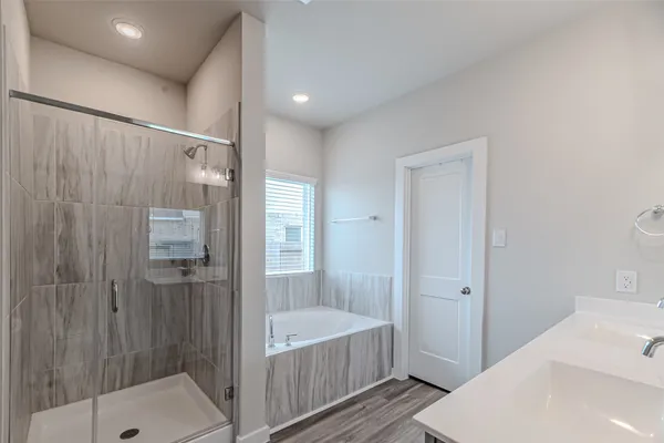 a bathroom with a bathtub and a shower