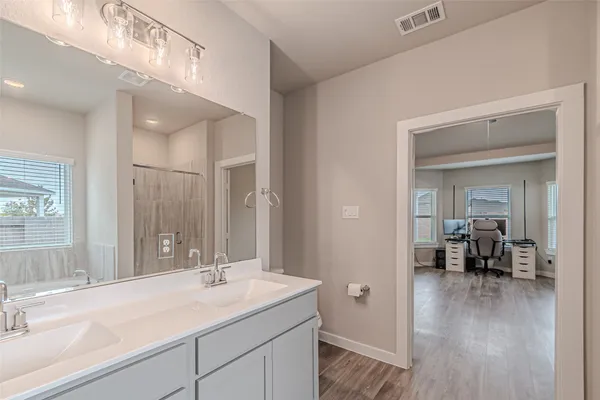 a en suite bathroom with a sink and mirror