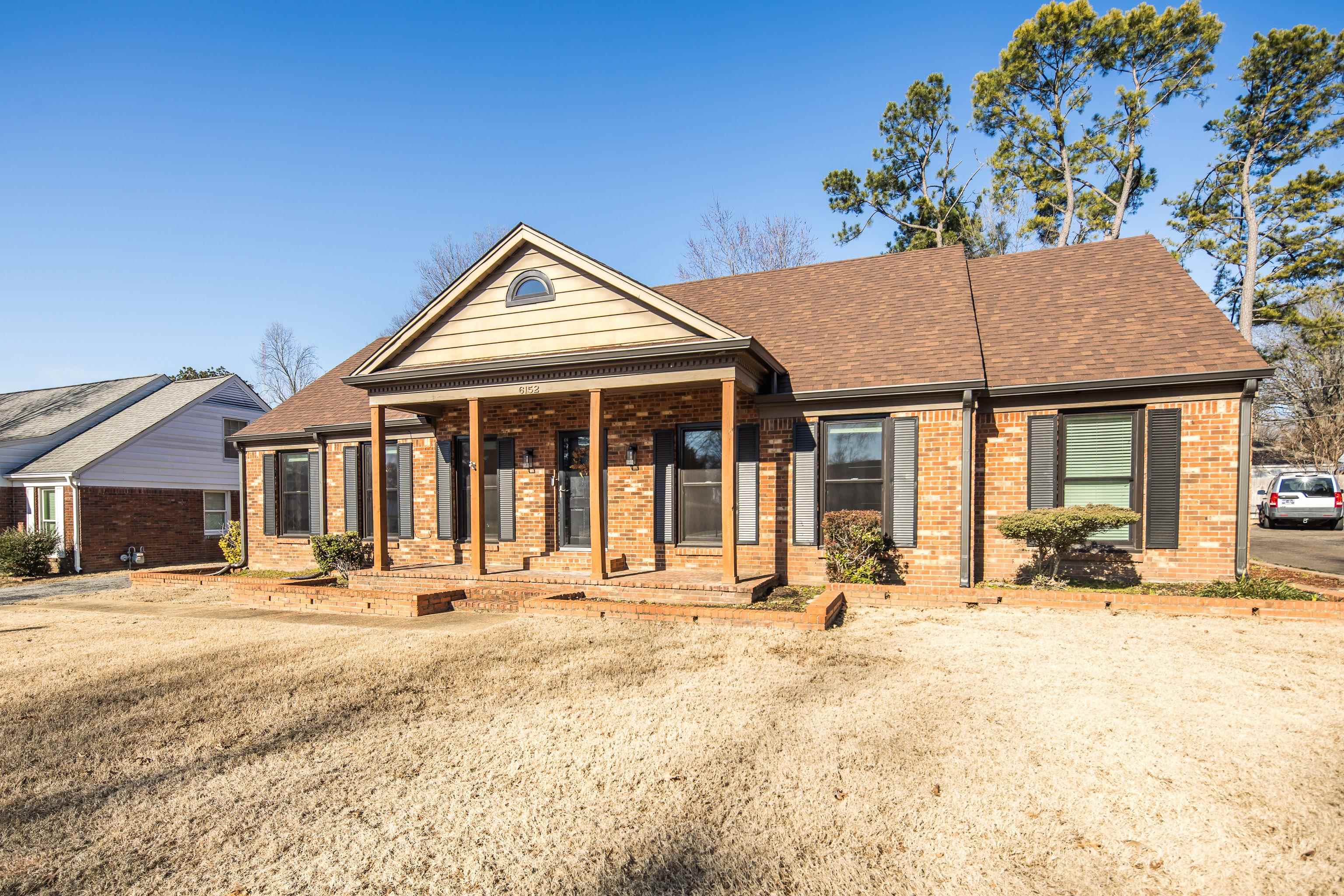 View of front of property with a front lawn and a porch