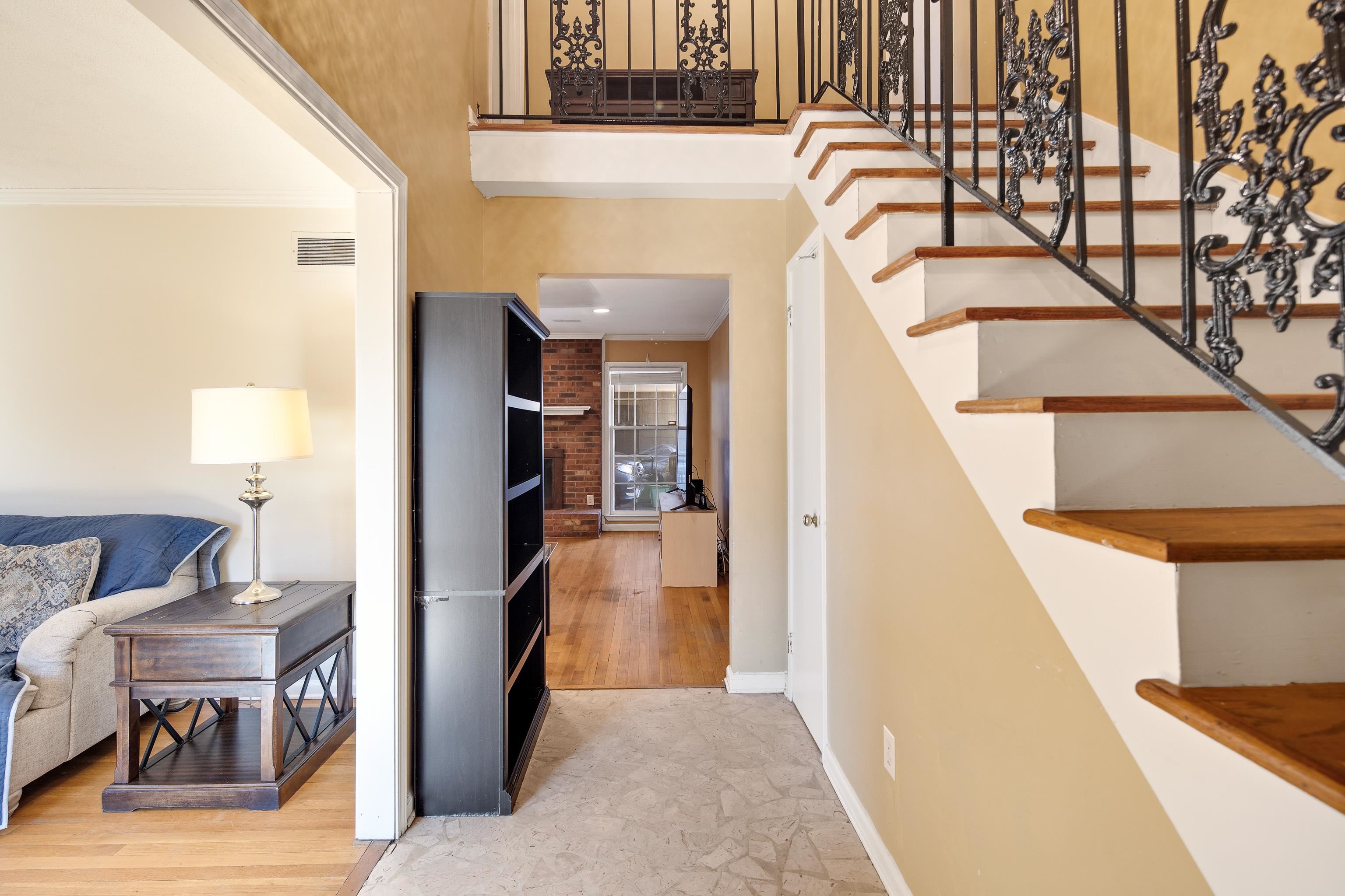 Interior space featuring crown molding and a towering ceiling