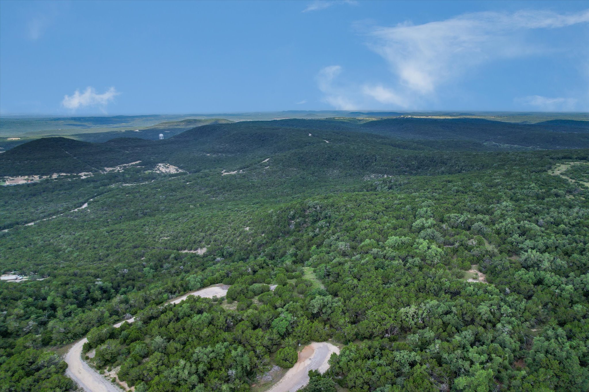 9404 Bar K Ranch Road Leander, TX 78645 - Photo 11 of 12 Sweeping views of verdant hills and natural terrain, offering a serene landscape.