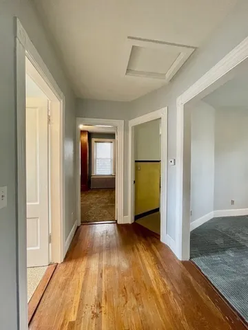 a view of hallway with wooden floor
