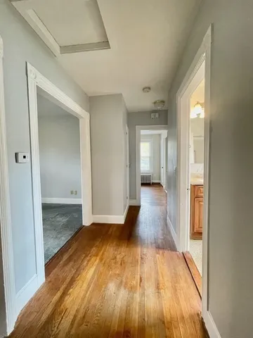 a view of hallway with wooden floor