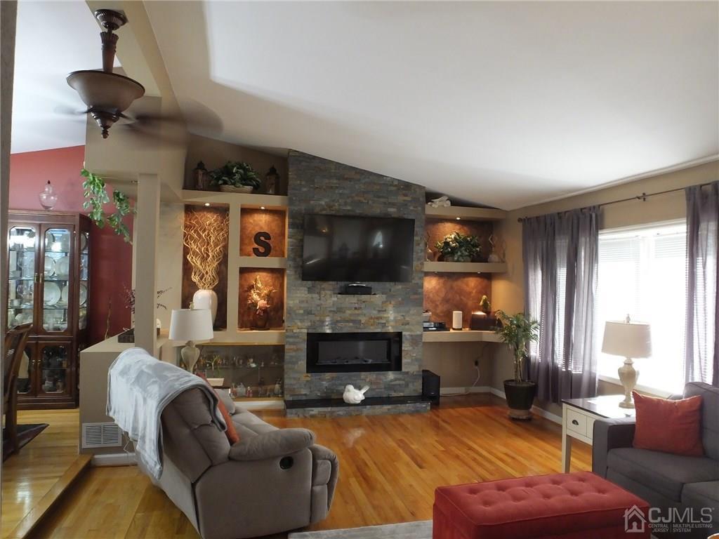 30 Peake Road Edison, NJ 08837 - Photo 6 of 25 a living room with furniture flat screen tv and a fireplace