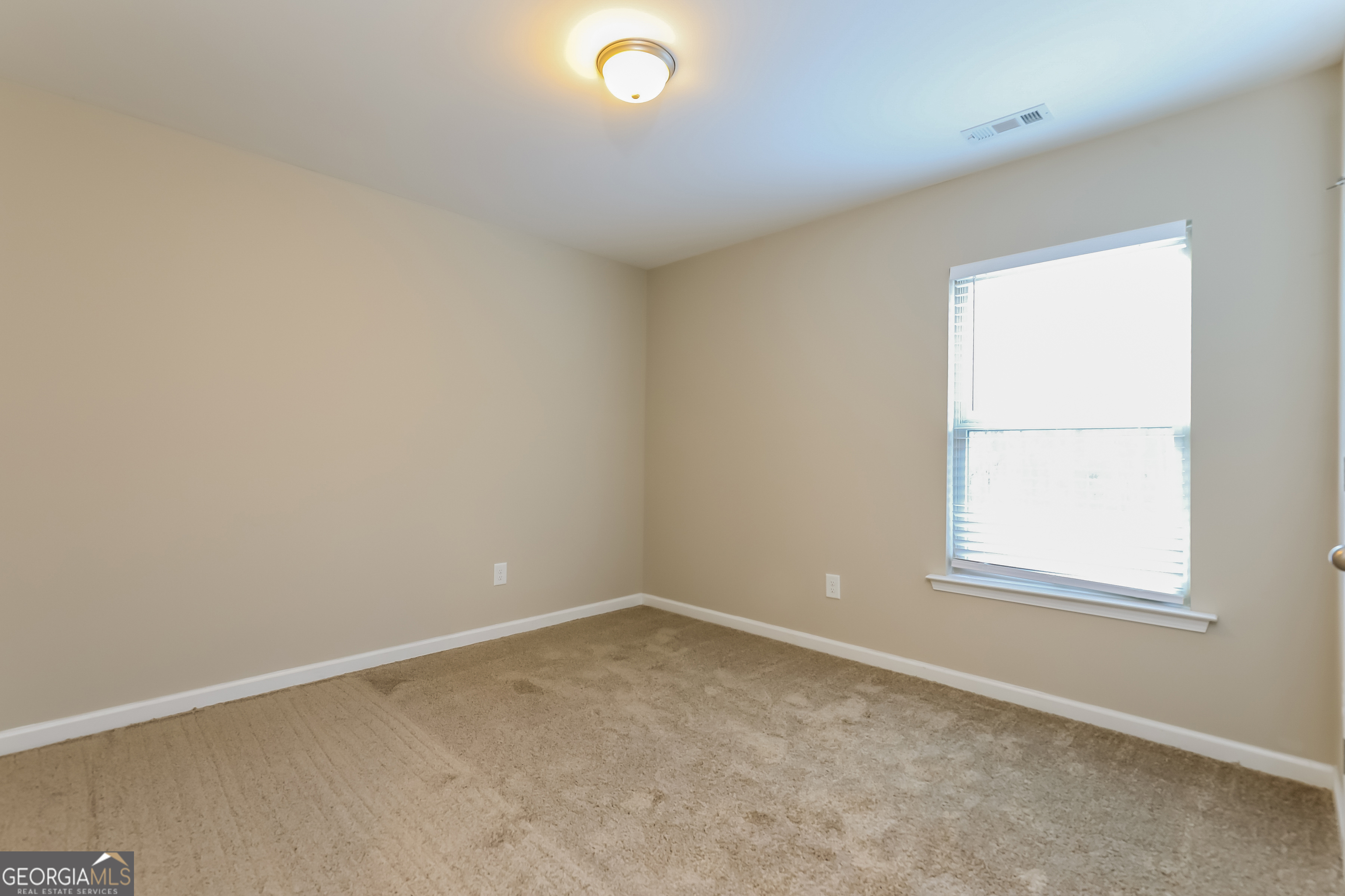 2518 Quincy Loop, Unit 90 Fairburn, GA 30213 - Photo 11 of 15 an empty room with a window
