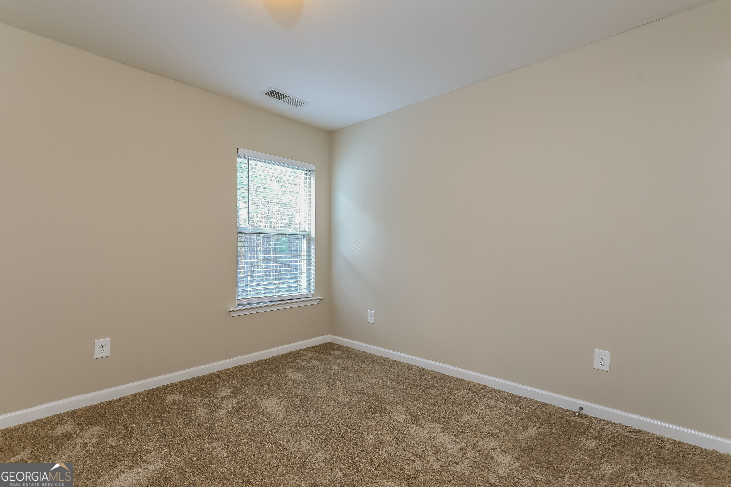 2518 Quincy Loop, Unit 90 Fairburn, GA 30213 - Photo 12 of 15 an empty room with a window