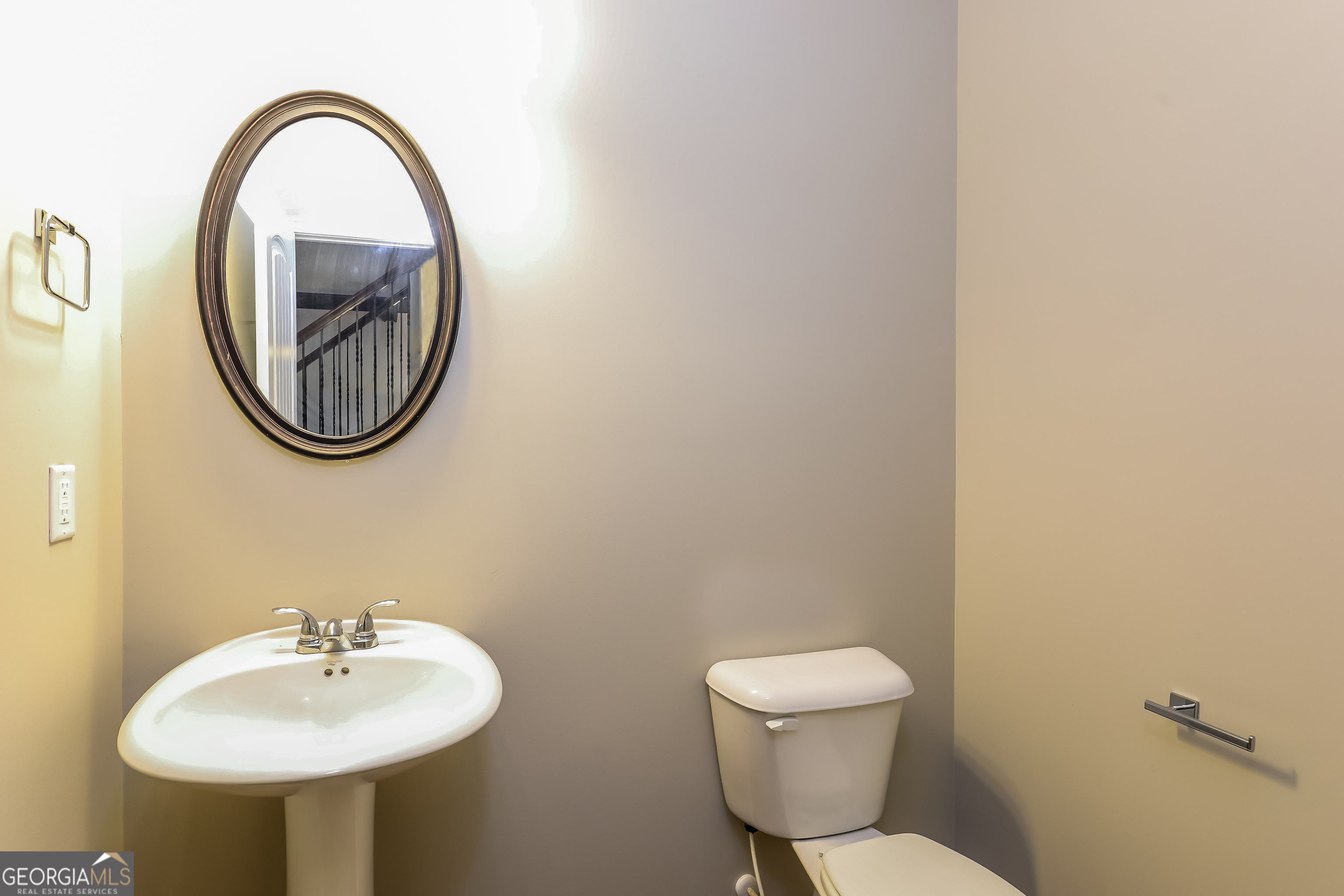2518 Quincy Loop, Unit 90 Fairburn, GA 30213 - Photo 13 of 15 a bathroom with a toilet a sink and a mirror