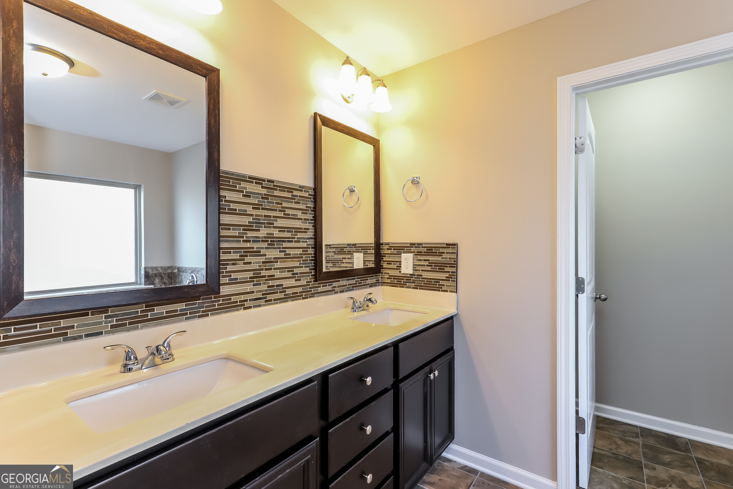 2518 Quincy Loop, Unit 90 Fairburn, GA 30213 - Photo 15 of 15 a bathroom with a double vanity sink mirror and double