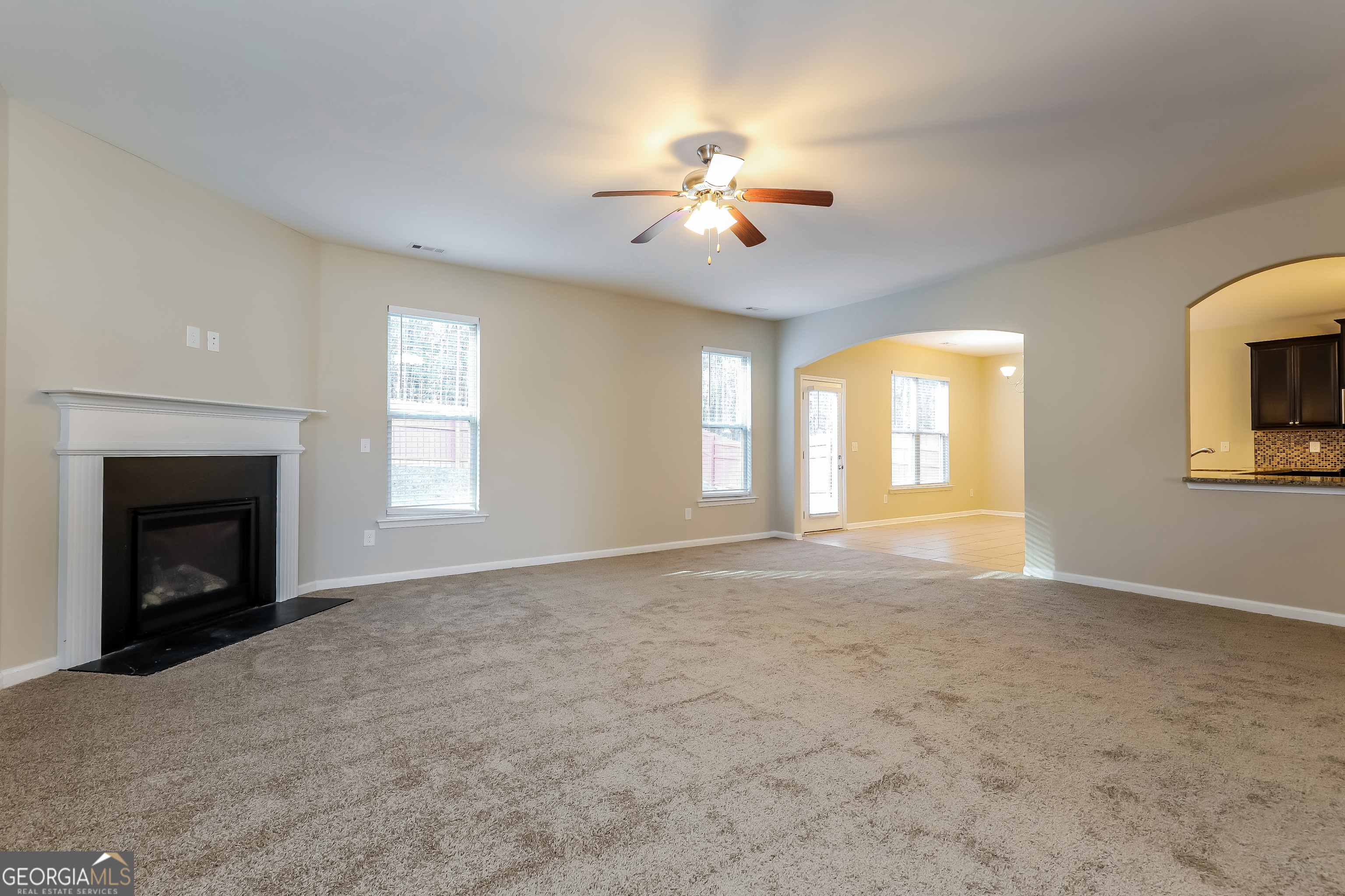 2518 Quincy Loop, Unit 90 Fairburn, GA 30213 - Photo 3 of 15 a view of an empty room with window and fireplace
