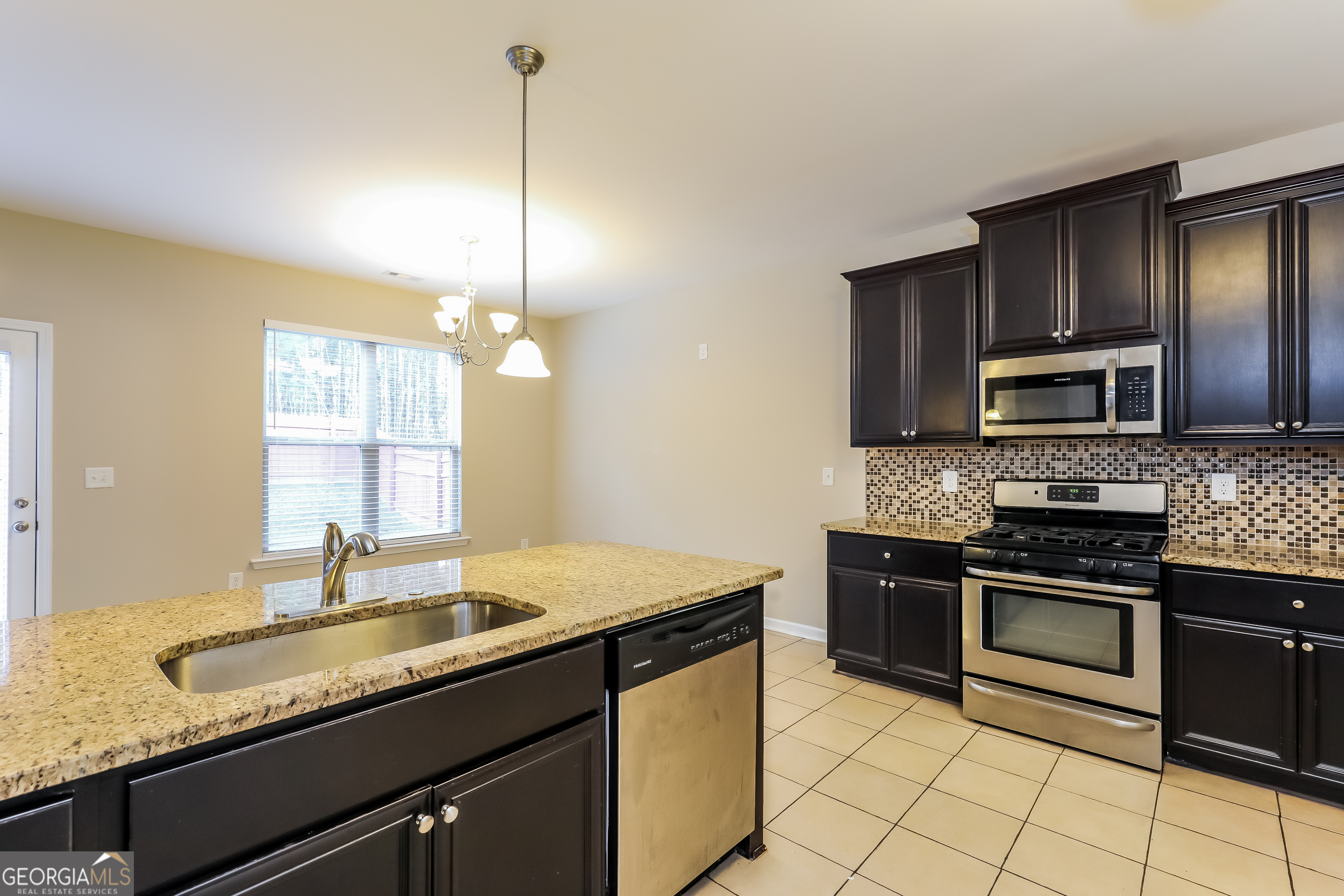 2518 Quincy Loop, Unit 90 Fairburn, GA 30213 - Photo 4 of 15 a kitchen with stainless steel appliances granite countertop a sink stove and refrigerator