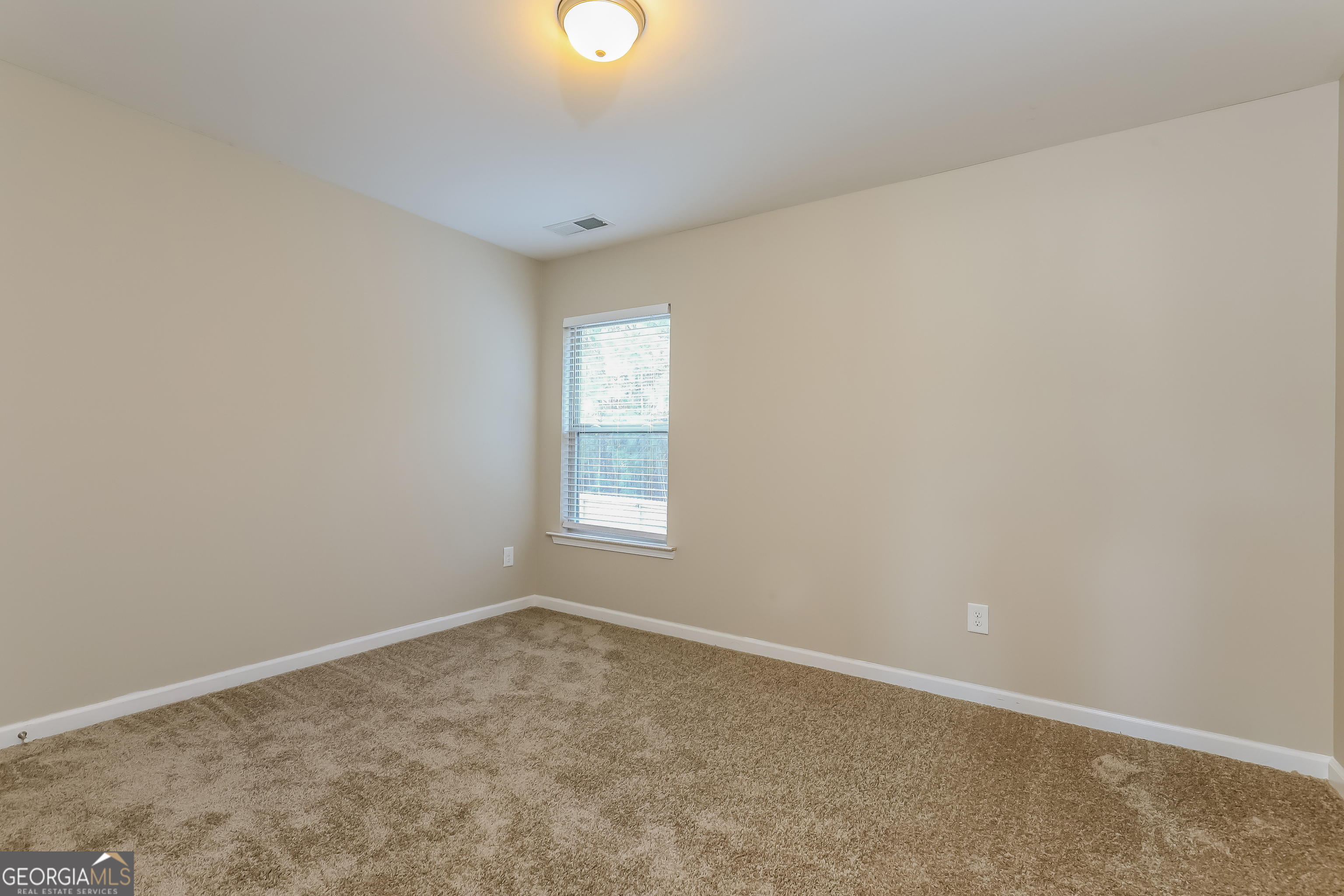 2518 Quincy Loop, Unit 90 Fairburn, GA 30213 - Photo 10 of 15 an empty room with a empty space and windows