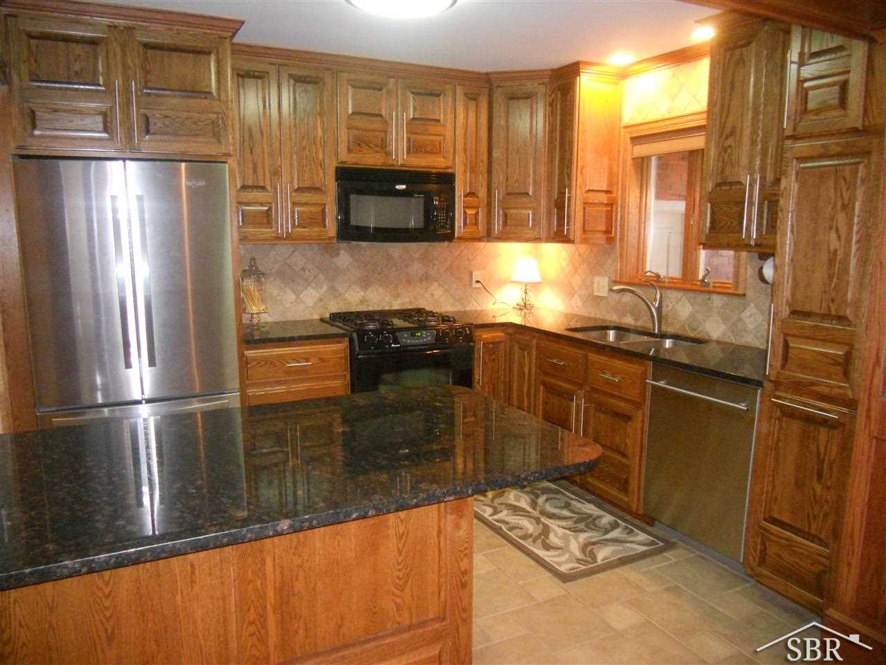 14745 Gratiot Road Hemlock, MI 48626 - Photo 6 of 17 Custom cabinetry, granite counters, tile backsplash and new appliances.