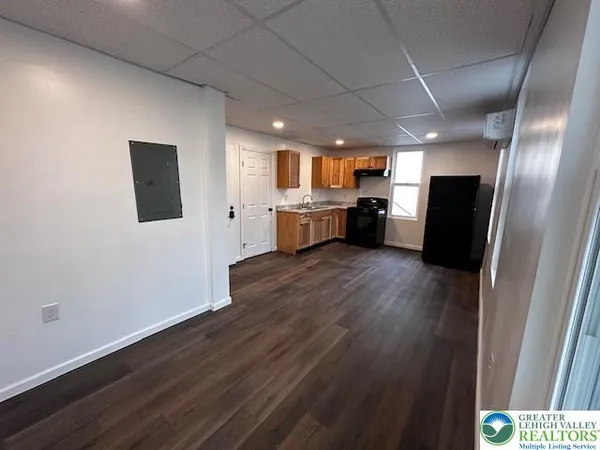 an empty room with wooden floor and furniture
