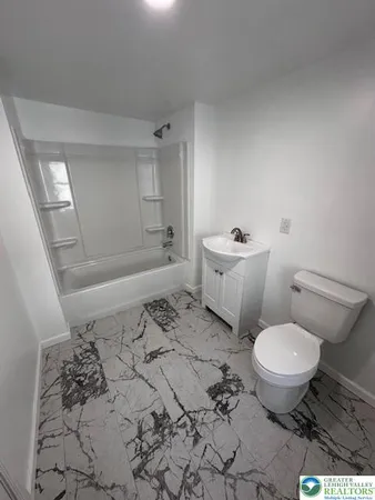 a bathroom with a toilet a sink and a bathtub