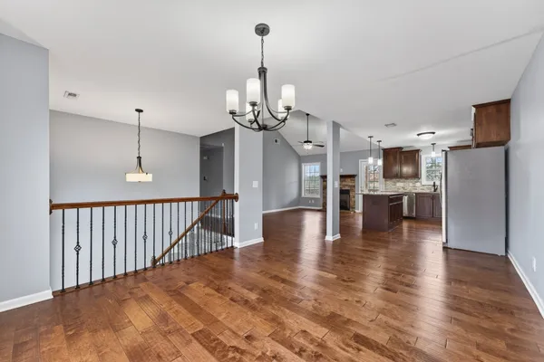 a view of a kitchen with a sink wooden floor and a kitchen view