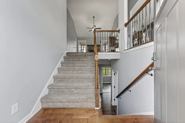 a view of entryway and hall with wooden floor