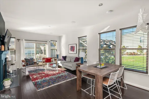 a living room with furniture and large windows