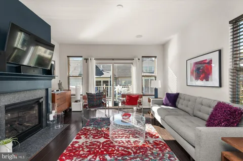 a living room with furniture fireplace and flat screen tv