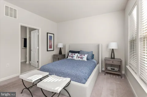 a bedroom with a bed a table and chair