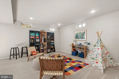a very nice looking room with kitchen island lots of furniture and screen