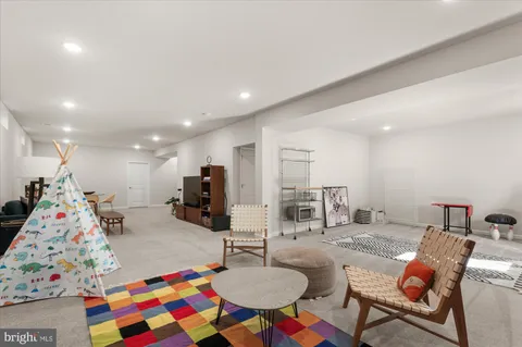 a bathroom with a granite countertop sink toilet and mirror