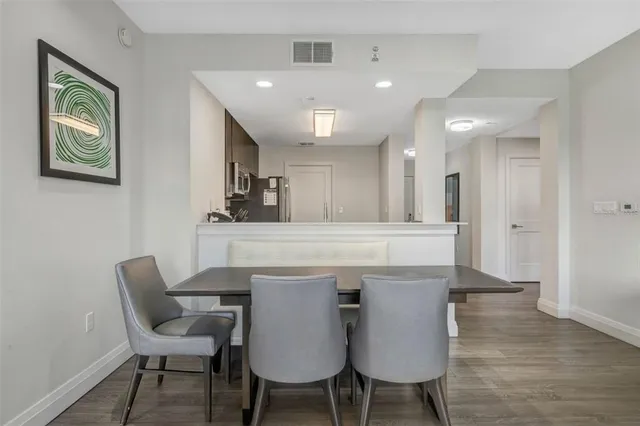 a view of a dining room with furniture and wooden floor