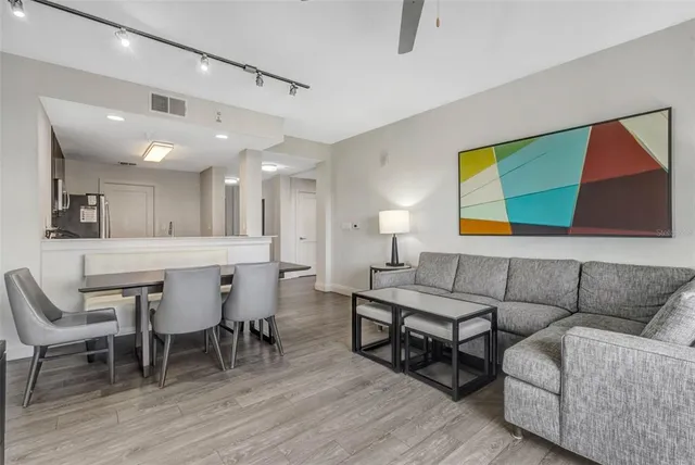 a living room with furniture and wooden floor