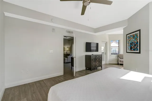 a bedroom with a bed and a television