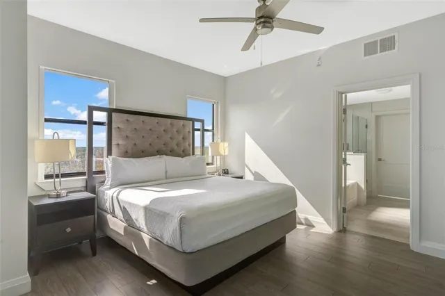 a bedroom with a large bed and a chandelier