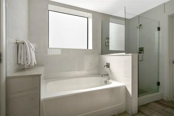 a bathroom with a bathtub and a shower