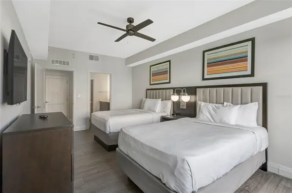 a bedroom with a large bed and a chandelier